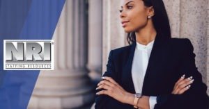 a confident lawyer with her arms crossed standing in front of a courthouse