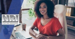 A smiling female administrative assistant at her desk